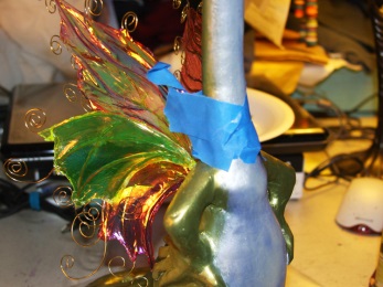 painters tape holding fairy wings in position on dragon